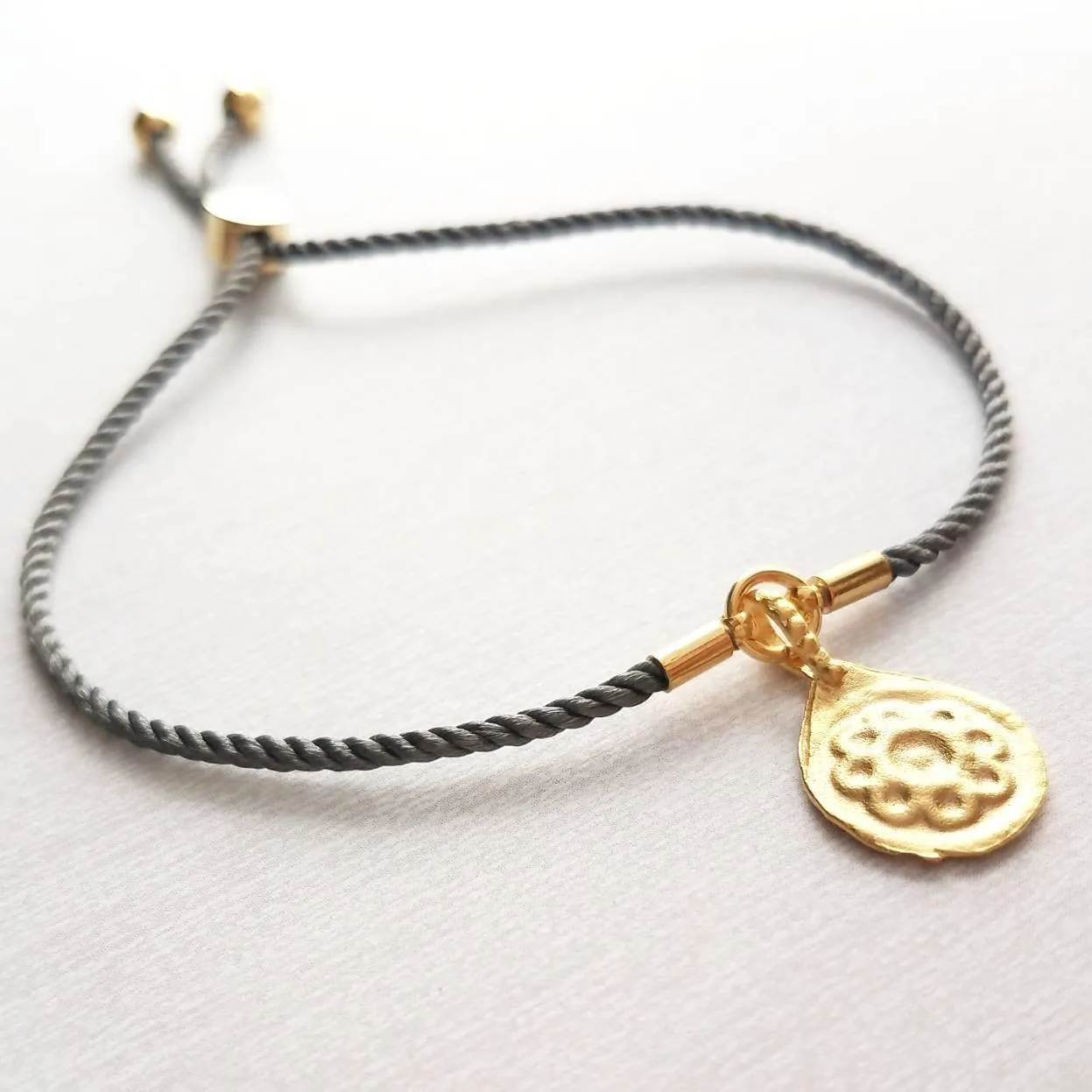 Cord Bracelet - grey silk style thin twisted rope - gold semicircle medallion charm - adjustable /one size fits most - gray stacking layer