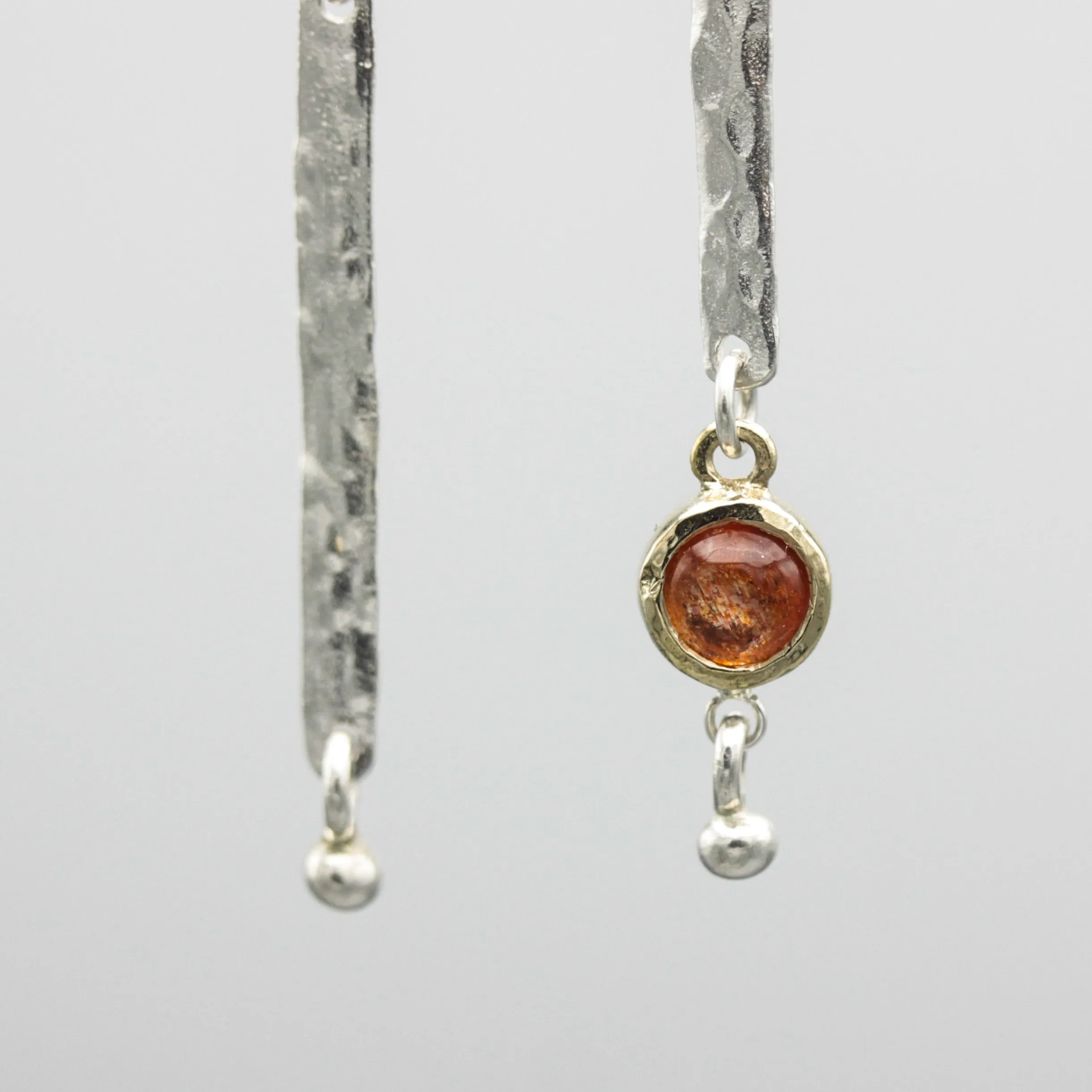 Round Sunstone earrings in brass bezel setting with silver bar hammer textured on sterling silver hooks style