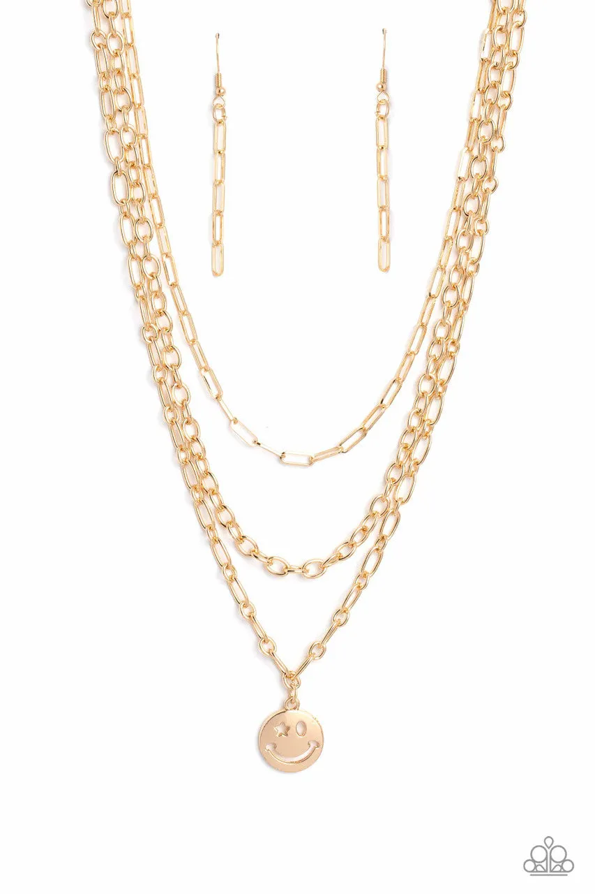 Winking Wanderer - Gold - Smiley Face Charm Tiered Chain Paparazzi Short Necklace - 2023 Empower Me Pink Exclusive