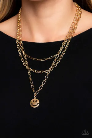 Winking Wanderer - Gold - Smiley Face Charm Tiered Chain Paparazzi Short Necklace - 2023 Empower Me Pink Exclusive